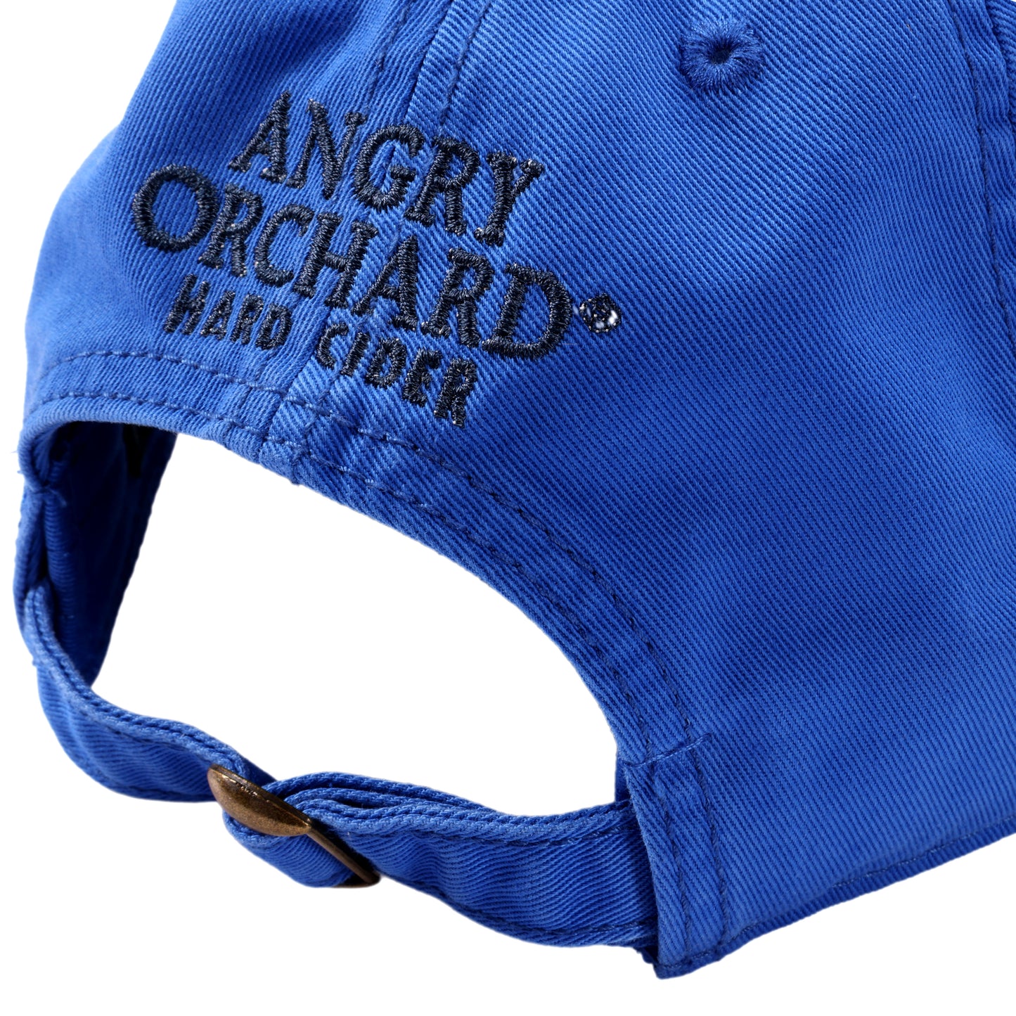 Back view of blue hat with writing "Angry Orchard Hard Cider" in black above adjustable strap with gold hardware.