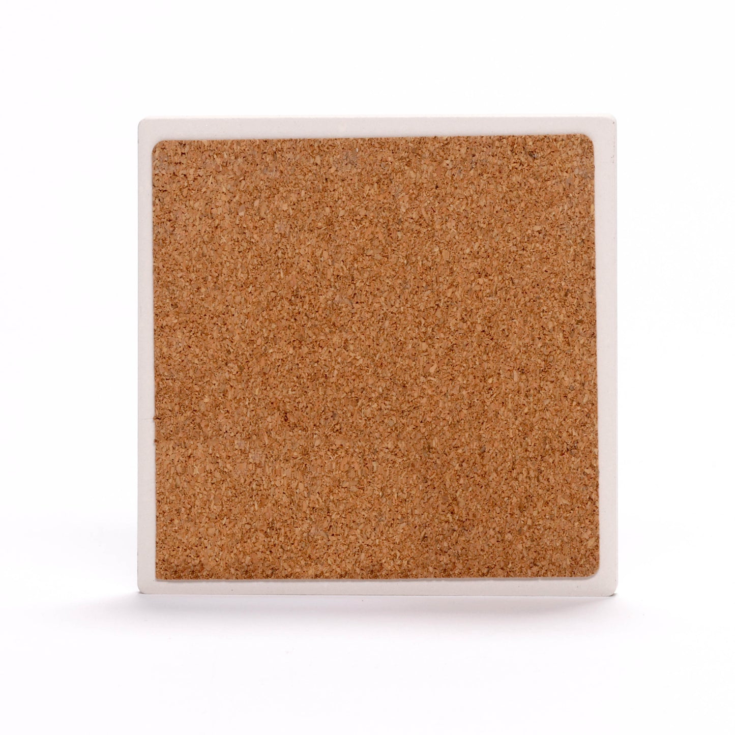 The back of a square coaster. The center is made of a cork material, while the outer edge is a white border.