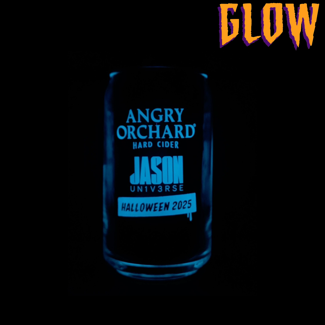 Angry Orchard hard cider can glass with Halloween-themed design featuring Angry Orchard Logo text and Jason Universe Halloween 2025 text. Word GLOW to describe one glass's glow in the dark feature.