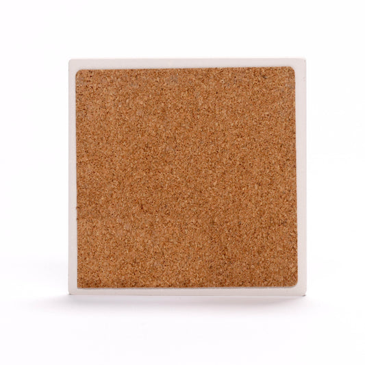 The back of a square coaster. The center is made of a cork material, while the outer edge is a white border.
