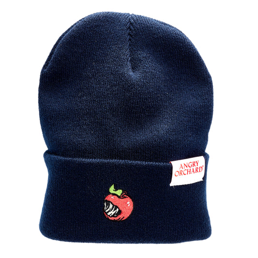 Navy beanie with red bitten apple on fold over. White Angry Orchard tag on the left side of fold over.