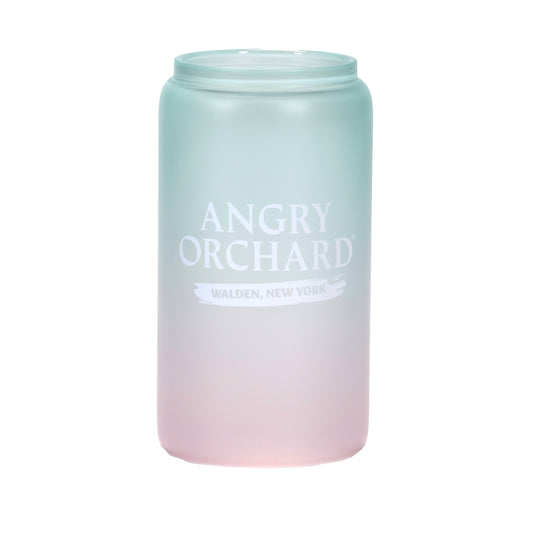 A frosted 16oz can-shaped glass with a pink-to-mint ombre gradient. One side shows the Angry Orchard logo with "Walden, New York" text; the other side features the brand's signature bitten apple icon. In a third image, the glass is filled with a frozen drink, revealing a bright red-to-blue ombre color change.