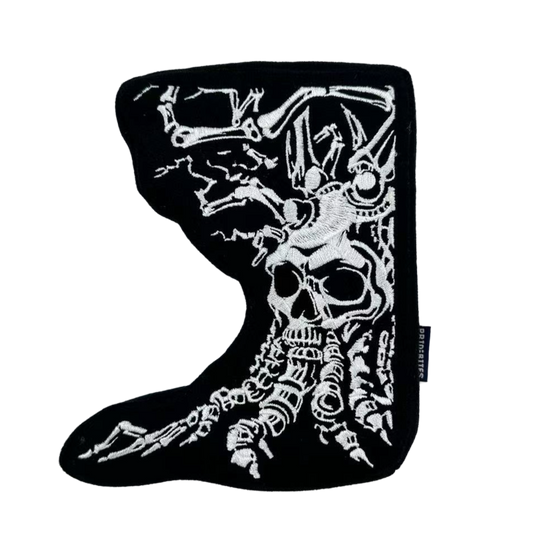 Front of black dog toy features Angry Tree in a white skeleton design.